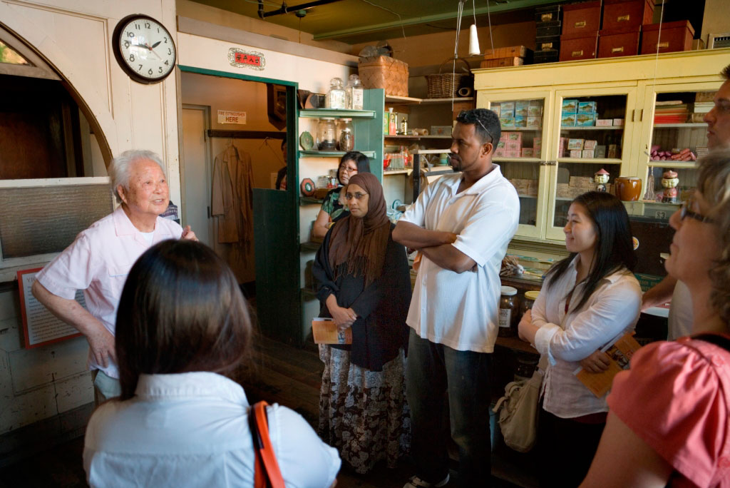 “Visitors at the Wing Luke Museum of the Asian Pacific American Experience explore the preserved Yick Fung Company store in Seattle's Chinatown‐International District, the only place in the continental United States where Chinese, Japanese, Filipino, Vietnamese, and other immigrants settled together. © Olson Kundig Architects”